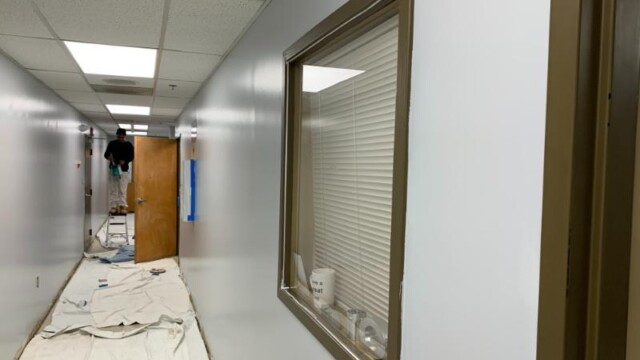 Hallway with tarp on the ground