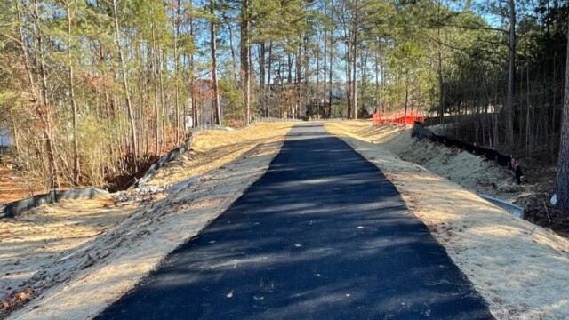 view from new asphalt path going towards tree line