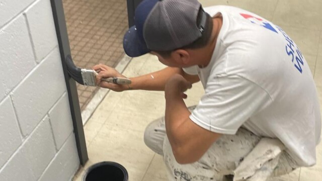 Man painting door frame