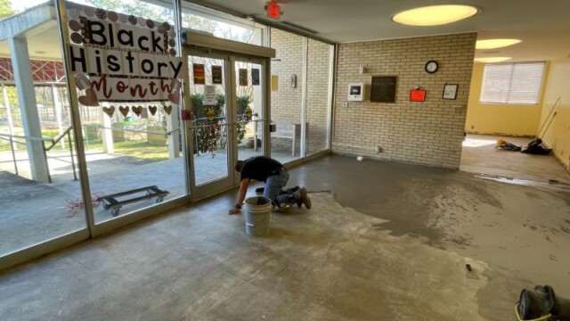 Worker prepares concrete floor