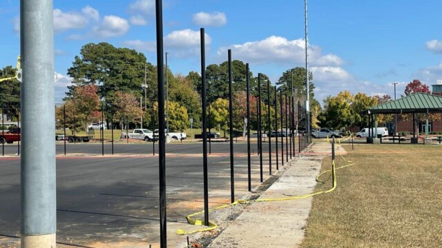 Fenceposts in holes at a community center