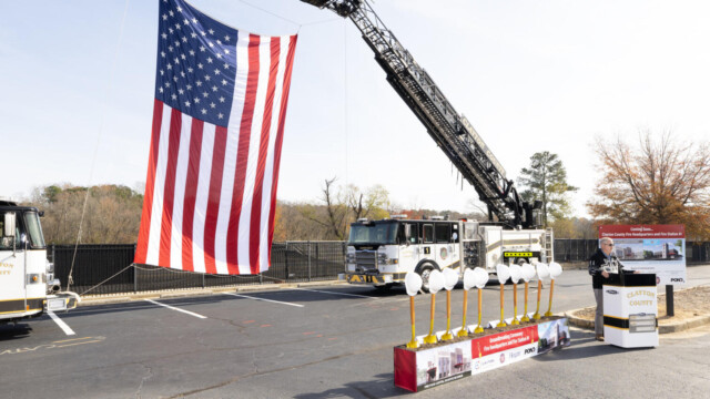 American flag flying from roof ladder of fire truck