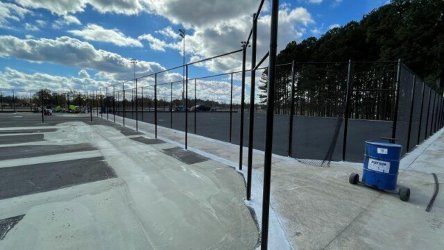 Fencing being installed on a mostly sunny day