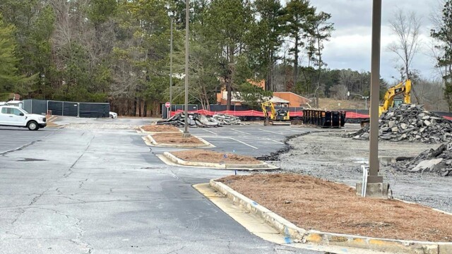 parking lot partially dug up with piles of asphalt