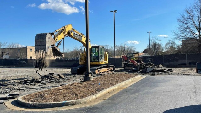 Forklift ripping up concrete ground