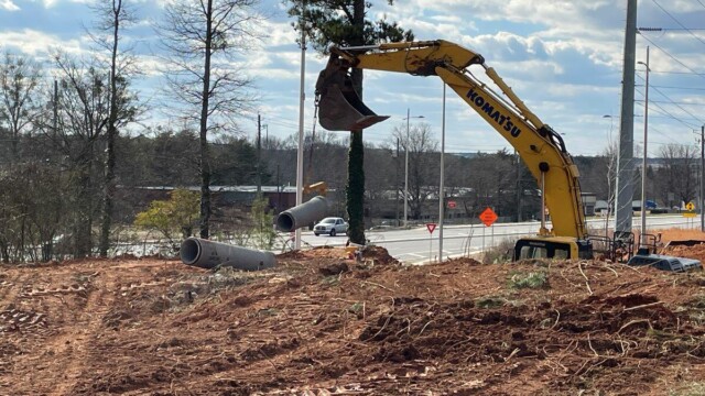 Fire Station 9 - Excavator Lifting Sewage Pipe Segment - Clayton County Fire Station 9 - Excavator Lifting Sewage Pipe Segment
