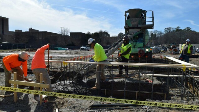 Construction workers pouring concrete