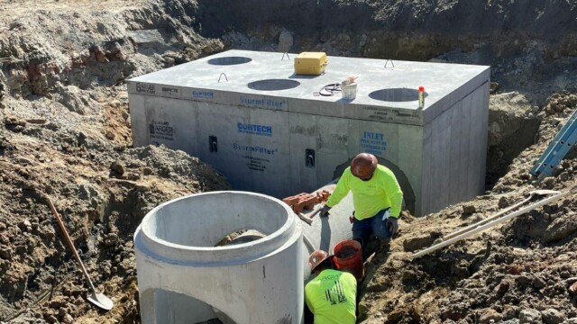 workers inside ground installing concrete foundations