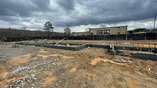 wide view of first few layers of cinder blocks making up new building