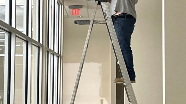 Small Business Incubator SPLOST update man fixing light fixture