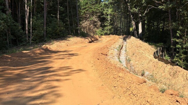 Rivers Edge dirt path into trees